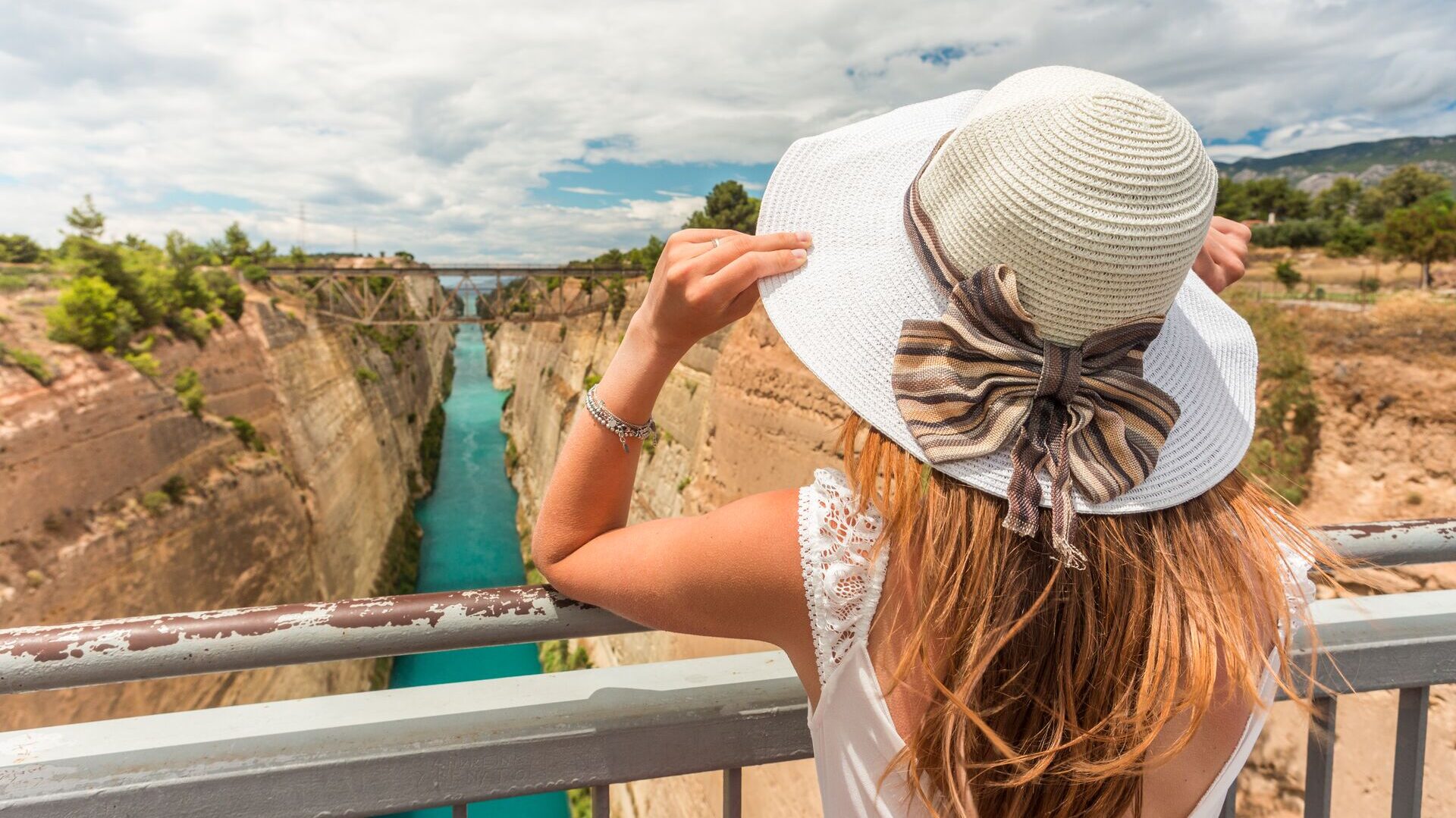 woman in a large sun hat in greece