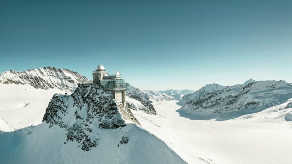 Observatory on a snowy mountain peak in Switzerland with expansive views of the surrounding alpine nature.