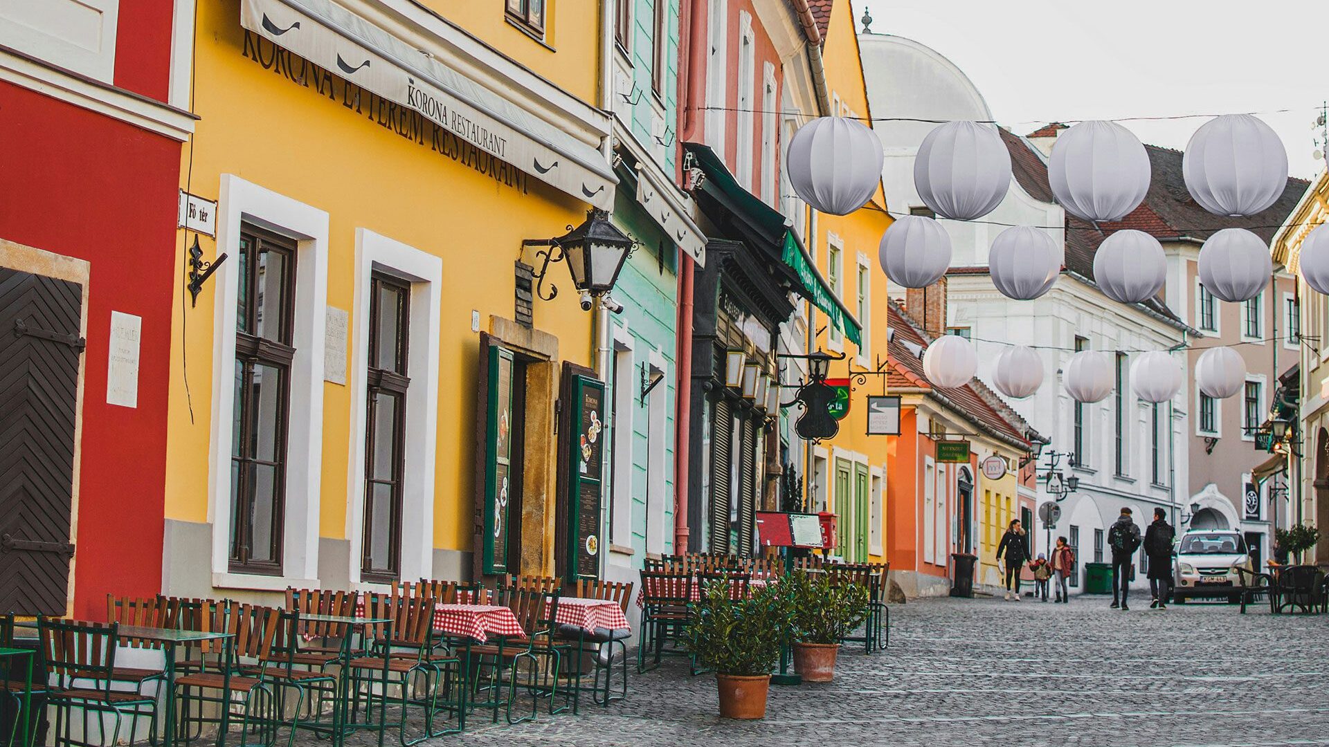 View of a cobbled street lined with colourful buildings