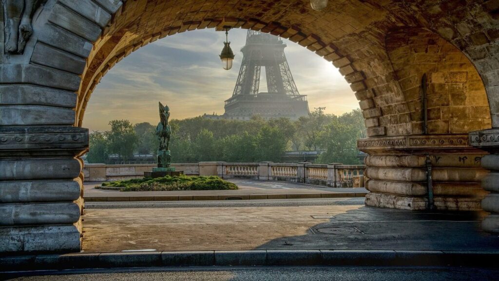 The Eiffel Tower from beneath a Parisan arch