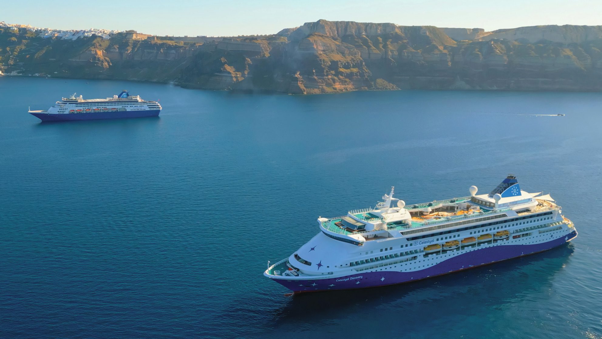 aerial view of two celestyal cruise ships in santorini