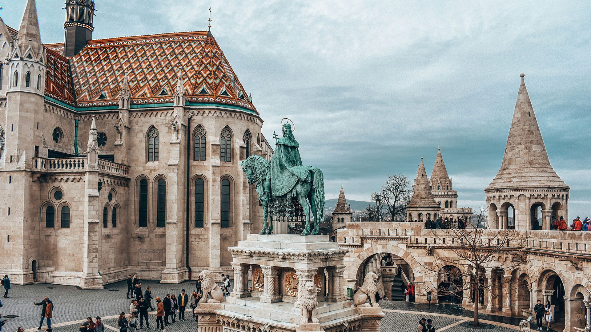 A sculpture stands in the middle of a courtyard within a medieval castle 