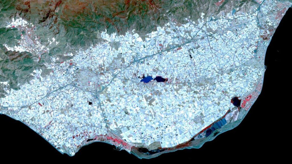 A city seen from space in blue and white.