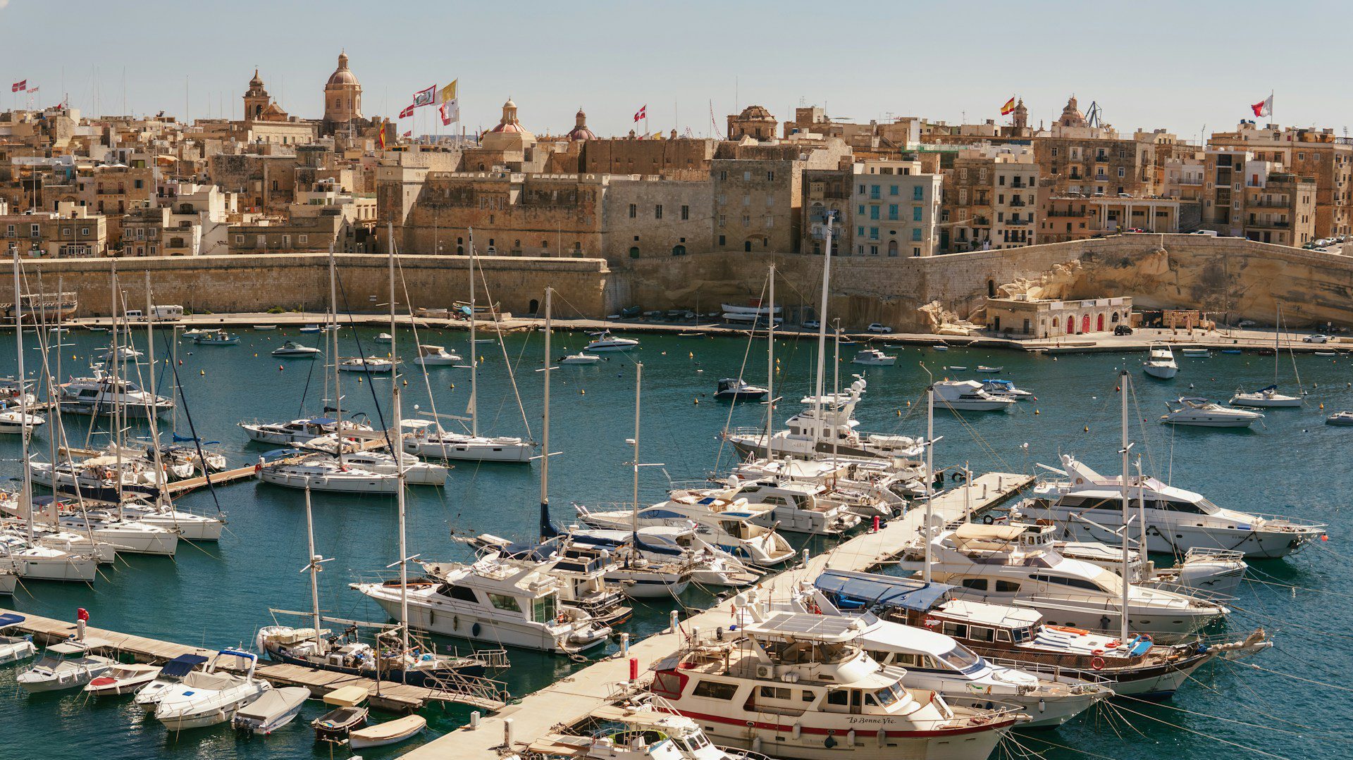View of Malta's harbor with sail boats in the foreground