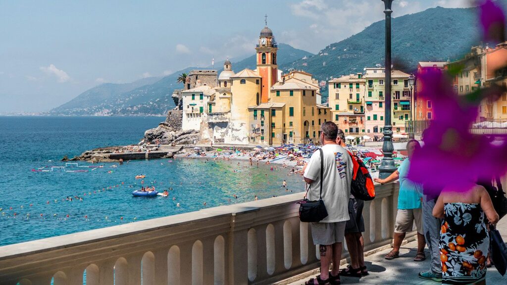 Couple looking out at the sea in a pretty beachside town