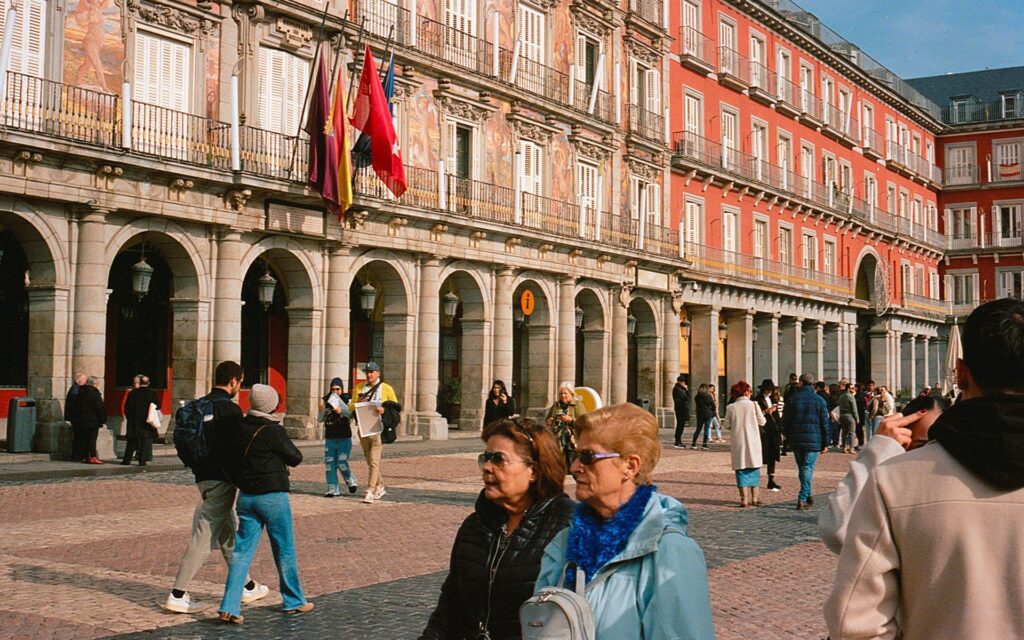 People walking through a square in a Spanish city