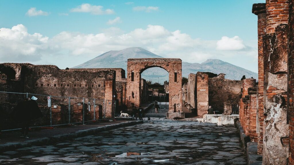 Ruins of Pompeii, Mount Vesuvius in the background. Cobbled street in the foreground.