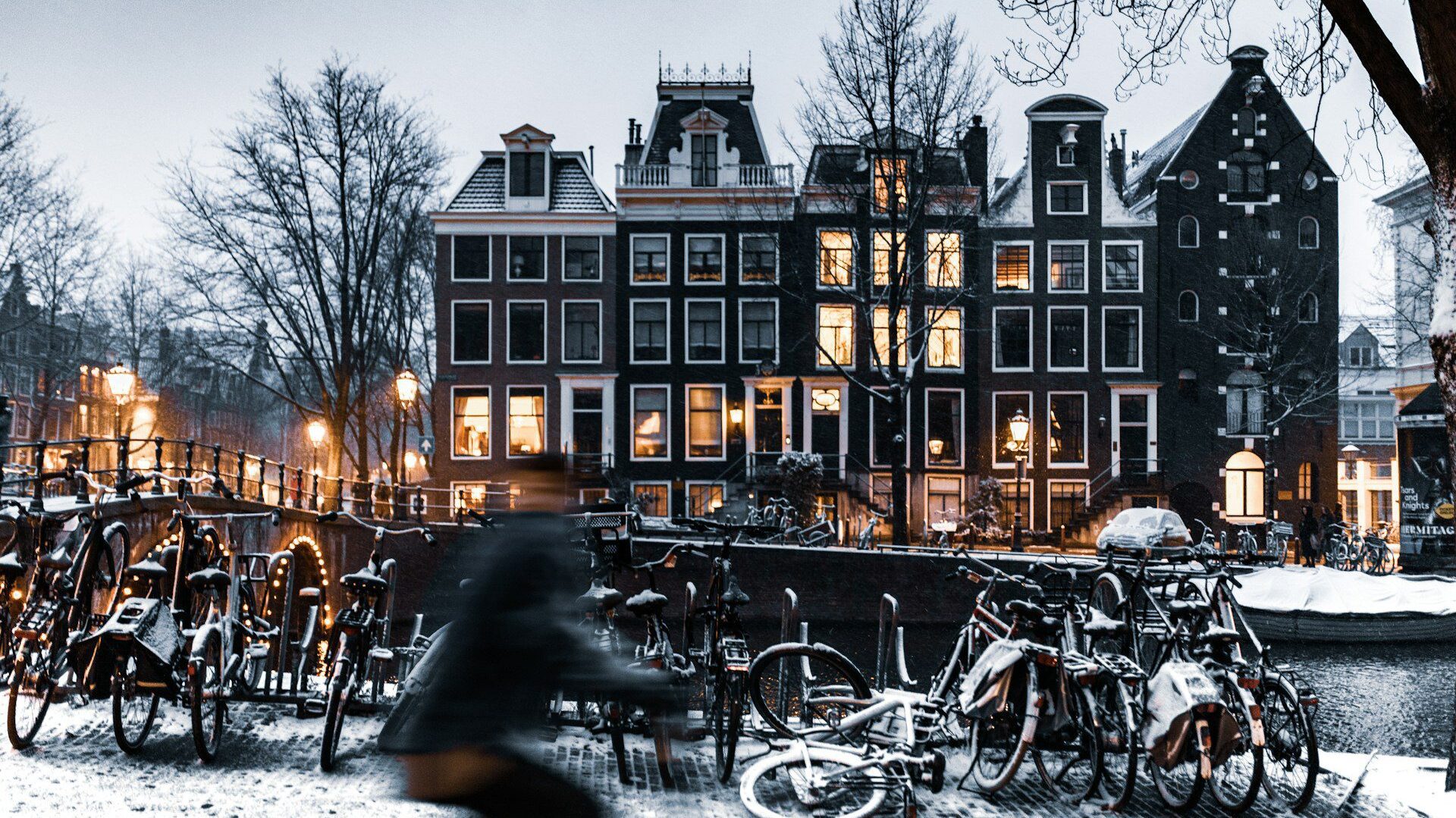 Photo of buildings alongside a canal in Amsterdam in the snow