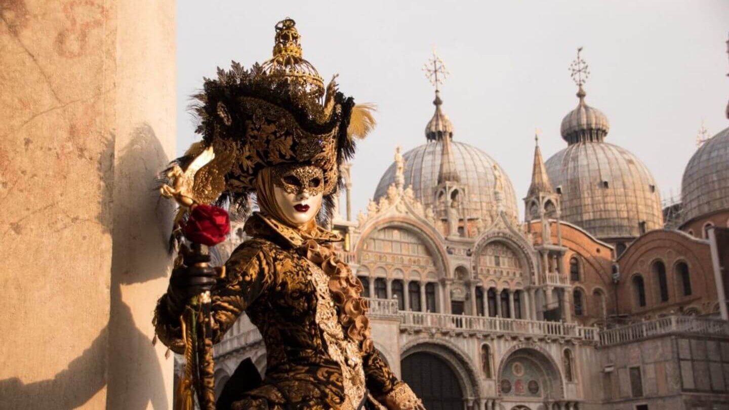 A woman in an ornate costume stands in front of a building during a family holiday.