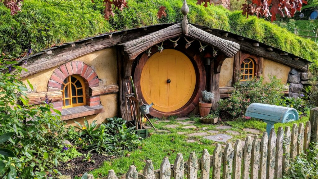 A typical hobbit house with a round door at Hobbiton in New Zealand