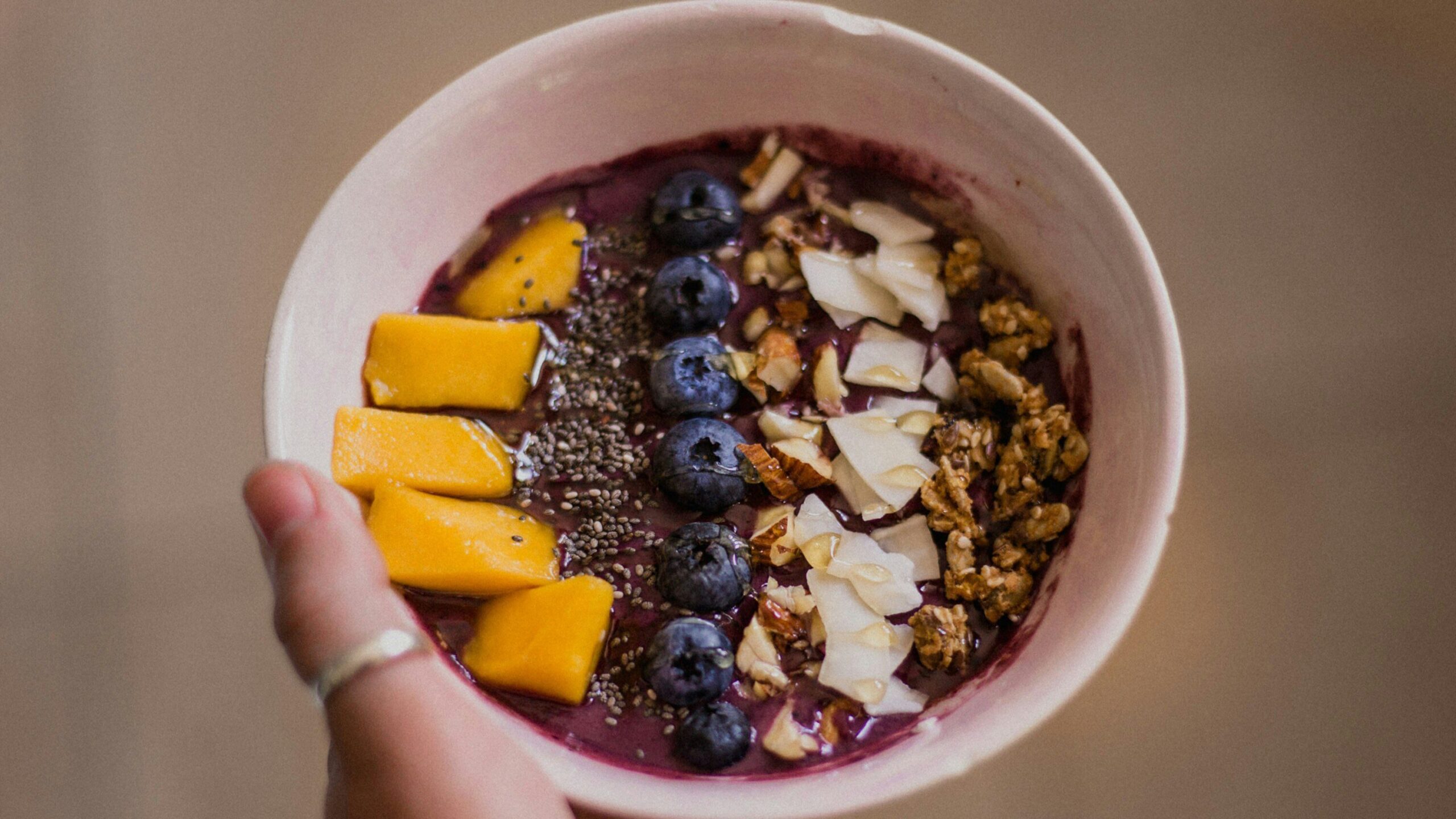 woman holding acai bowl