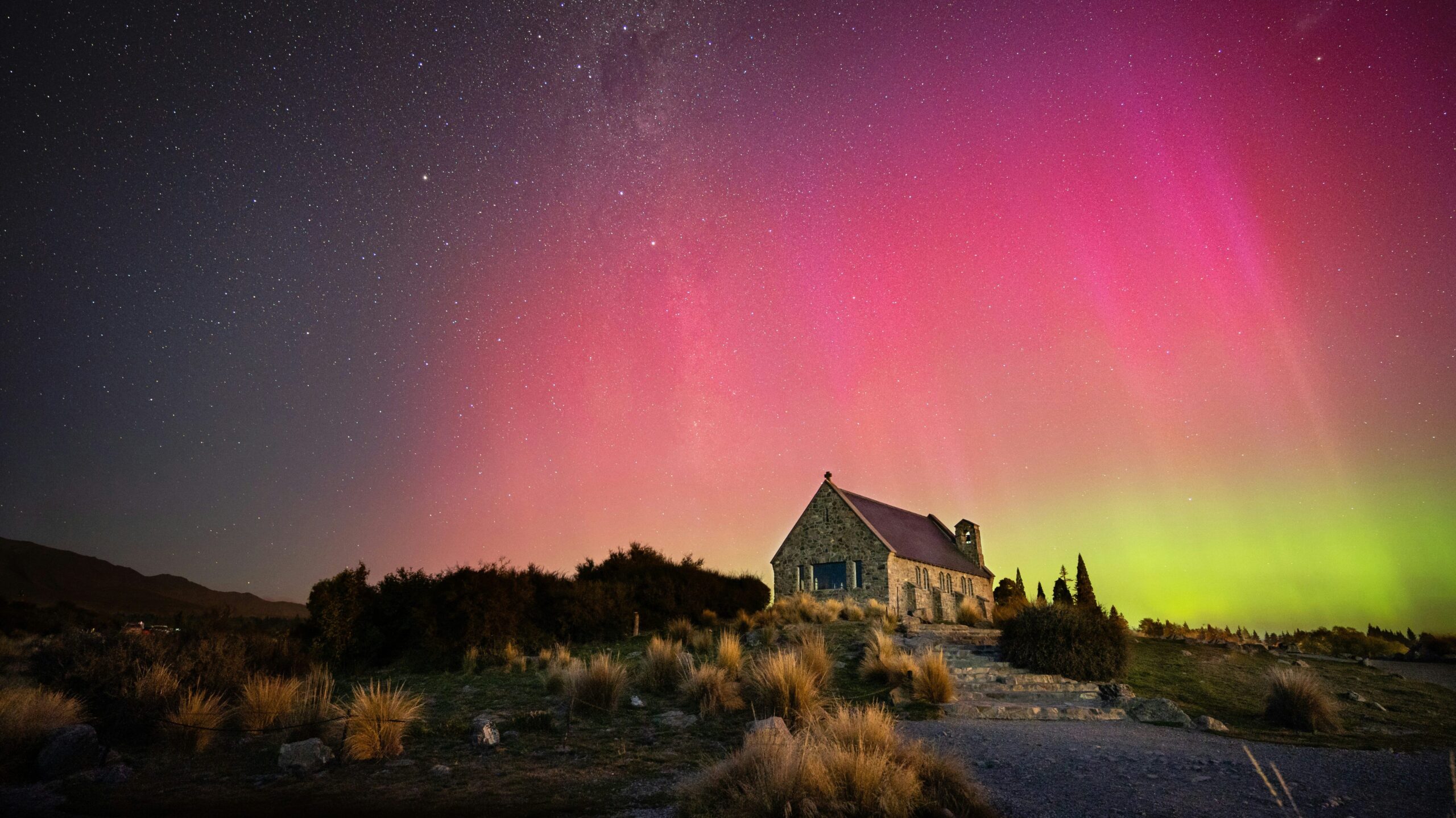 aurora australis over a church in new zealand