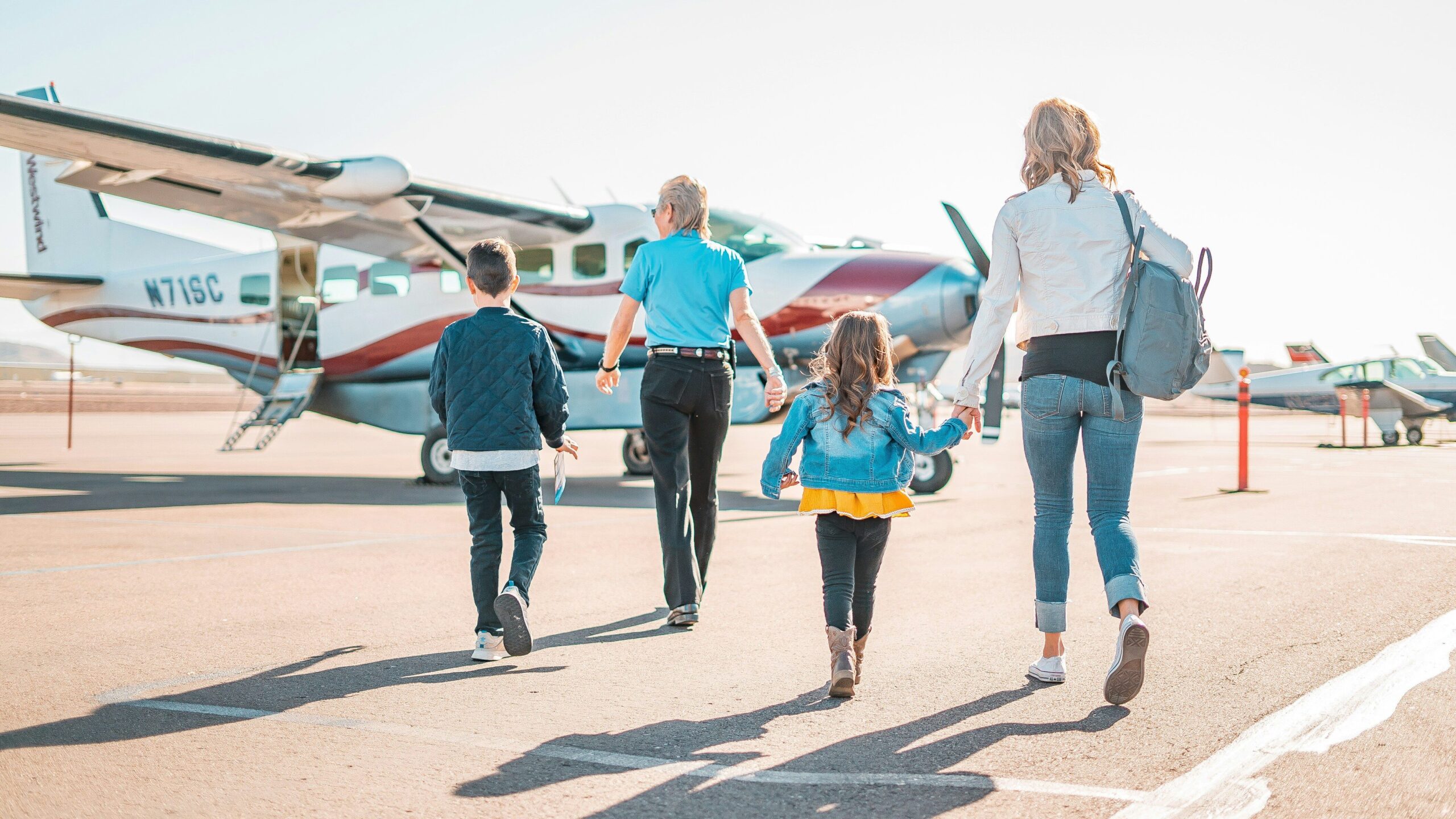 family walking to airplane