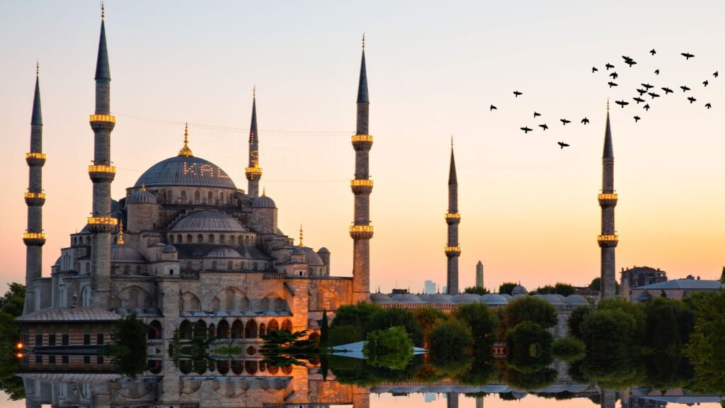 Traveling solo, I marveled at the breathtaking view of the Blue Mosque reflecting on the water during sunset.