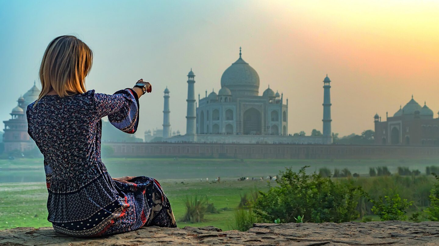 woman looking at the taj mahal
