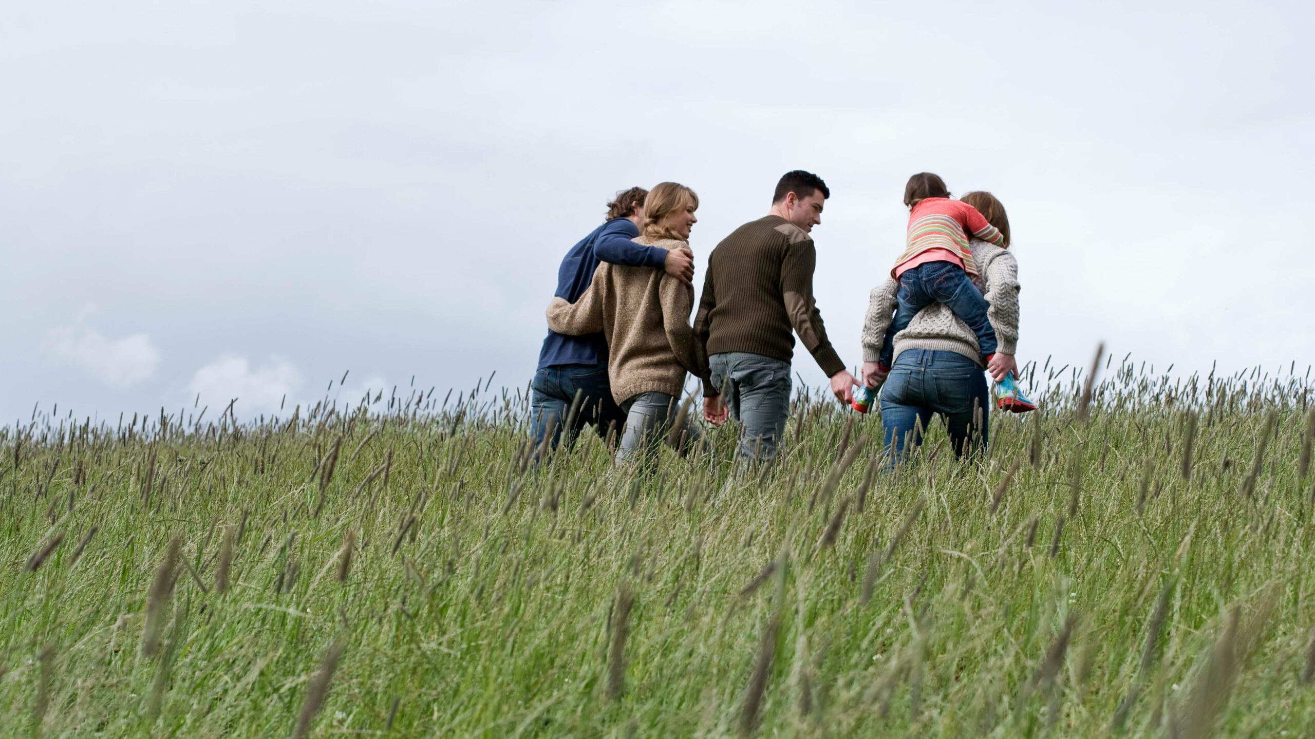 family walking through a field in ireland