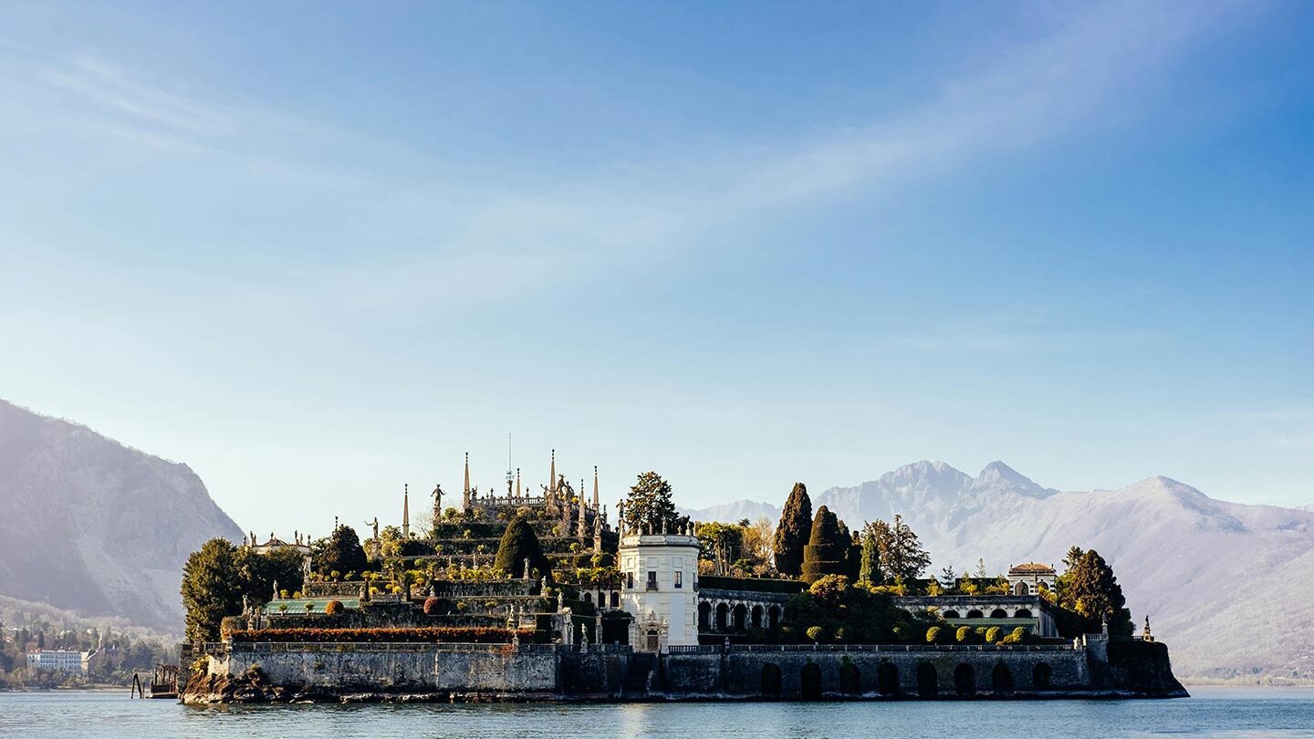 Palace of Borromeo on Lake Maggiore, lake surrounds the building. Blue skies.