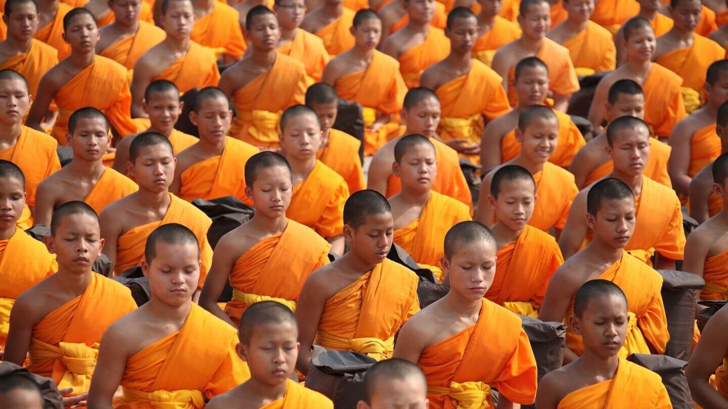 Buddhist monks in orange robes meditating Asian traditions