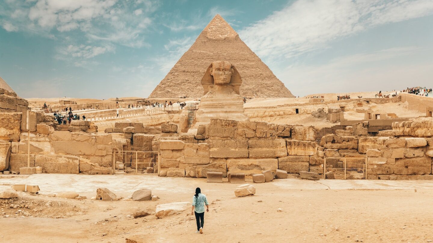 Woman in Egypt walking towards the Sphinx