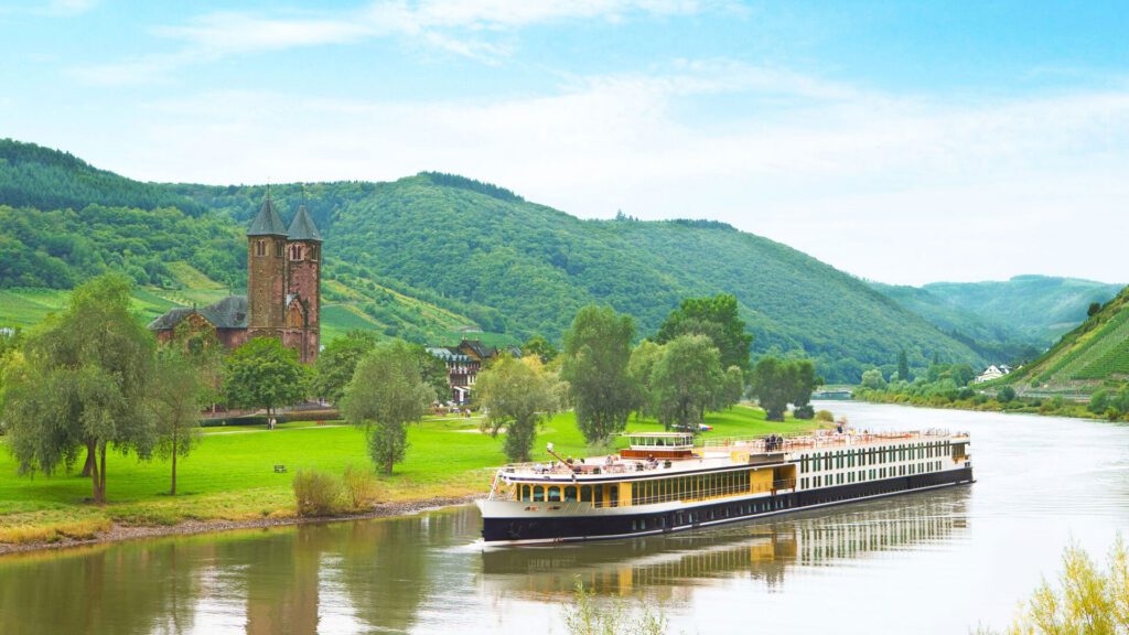 river cruise ship passing an old church 