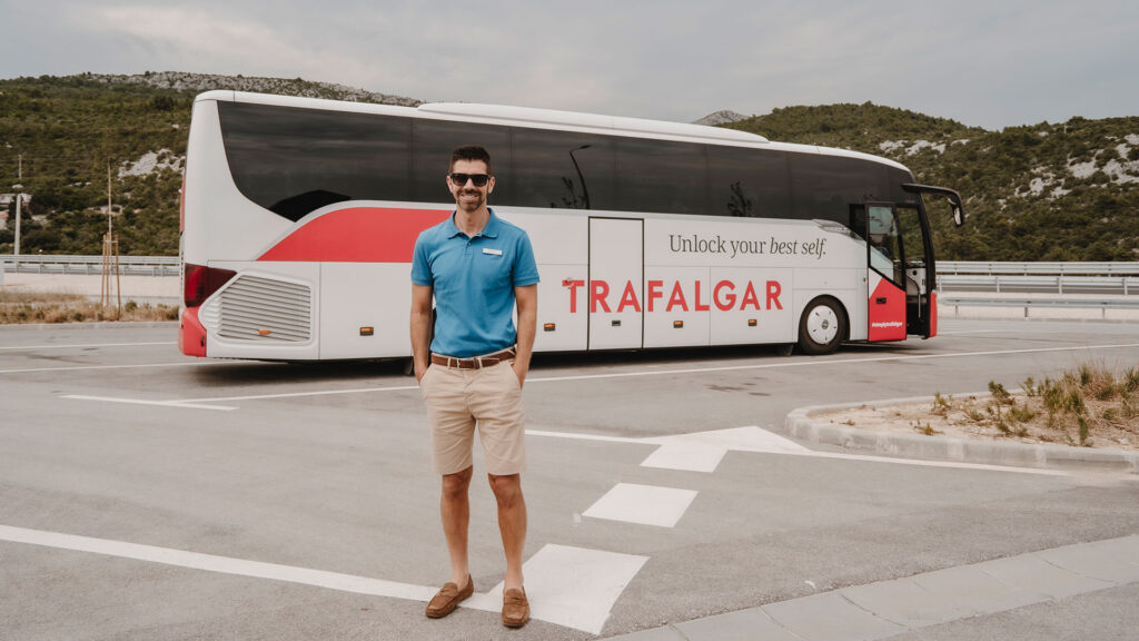 Tod standing in front of a Trafalgar coach