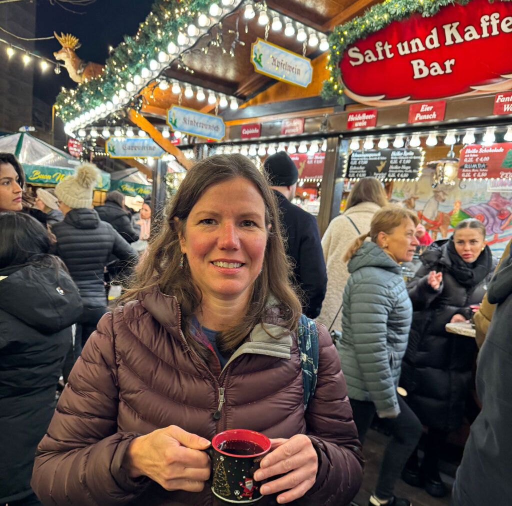 Danielle holding a mug of mulled wine at a Christmas market