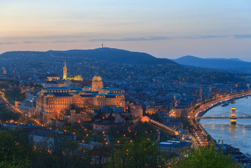 View of Buda Castle and the Danube lit up in the dusk light
