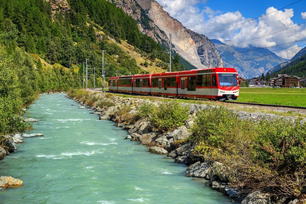 Electric train in Switzerland alongside a river