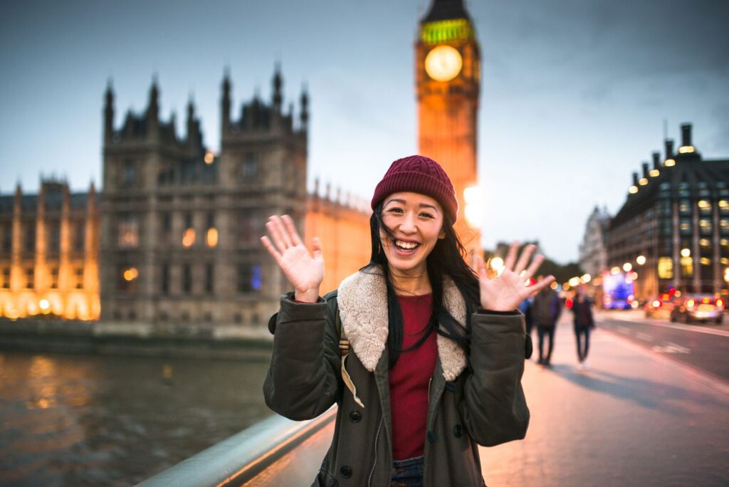 woman posing for photo in front of big ben, london