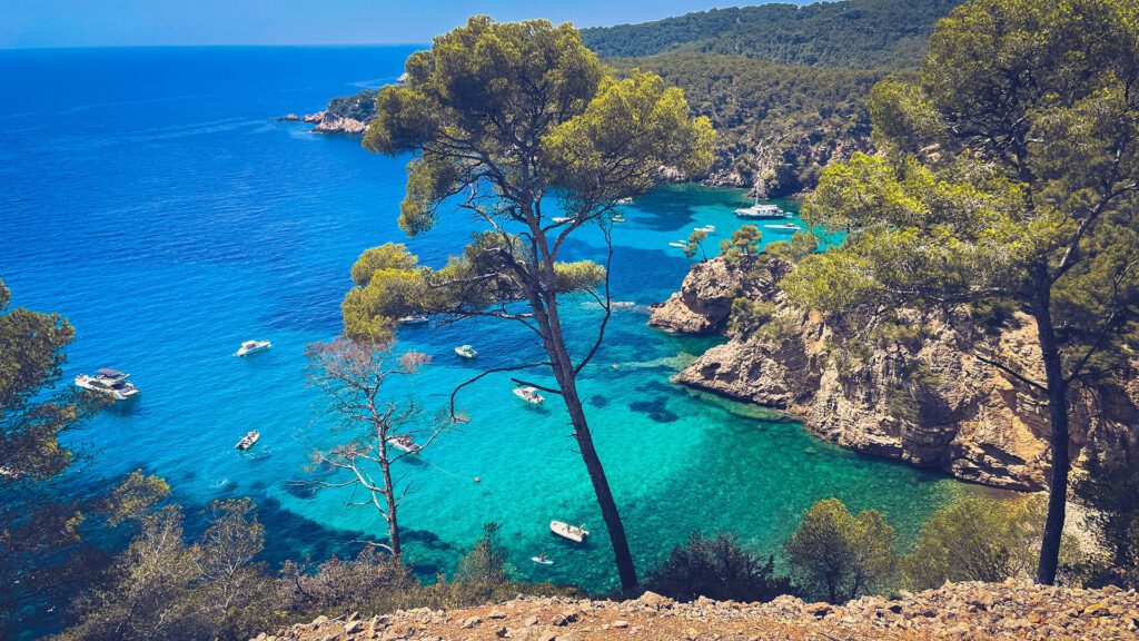View overlooking a shallow blue water cove somewhere in the Mediterranean Sea with small boats