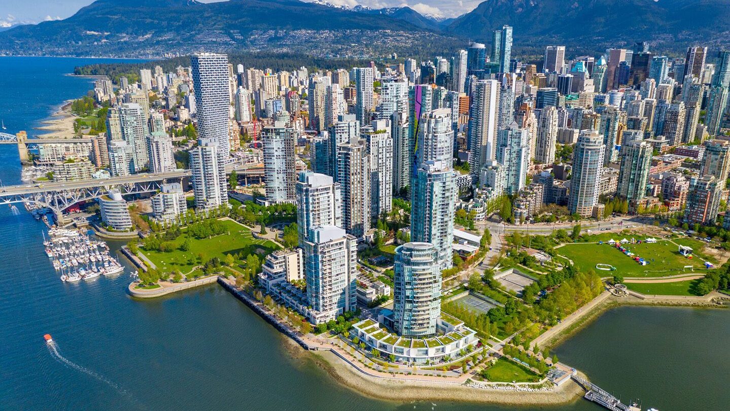 Aerial view of Downtown Vancouver with Rocky Mountains in the background