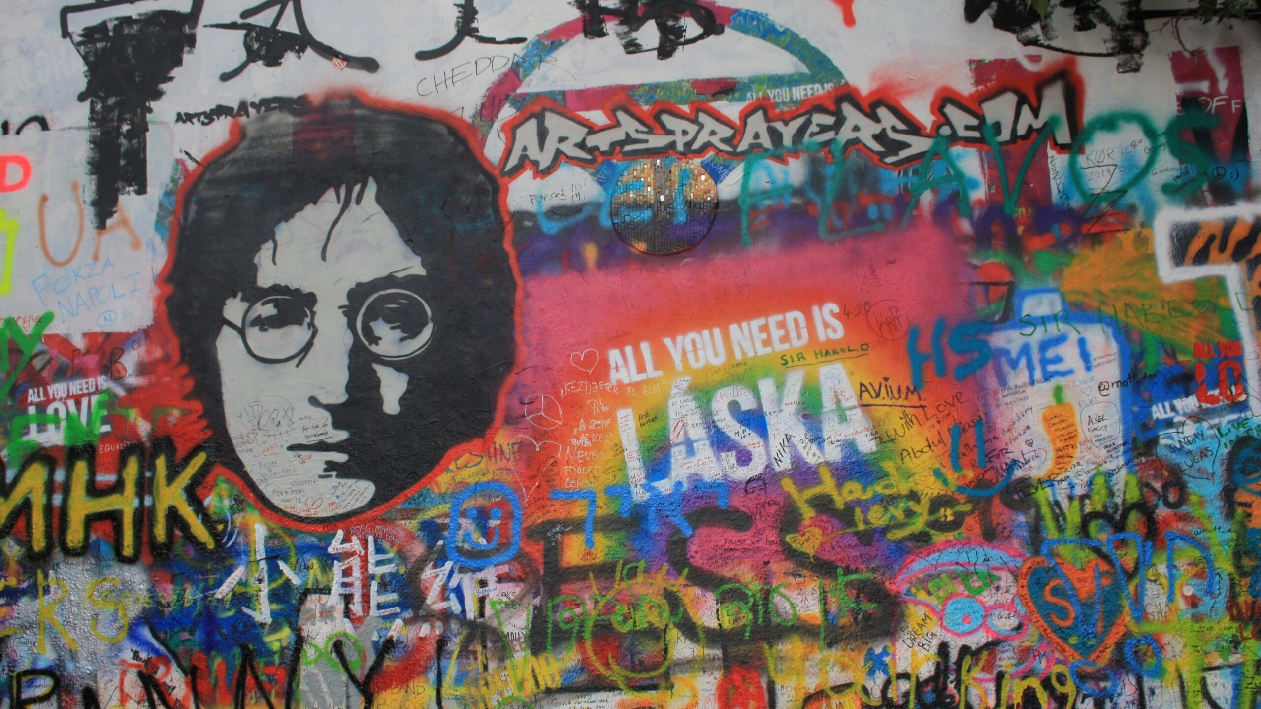 Wall of graffiti featuring image of John lennon
