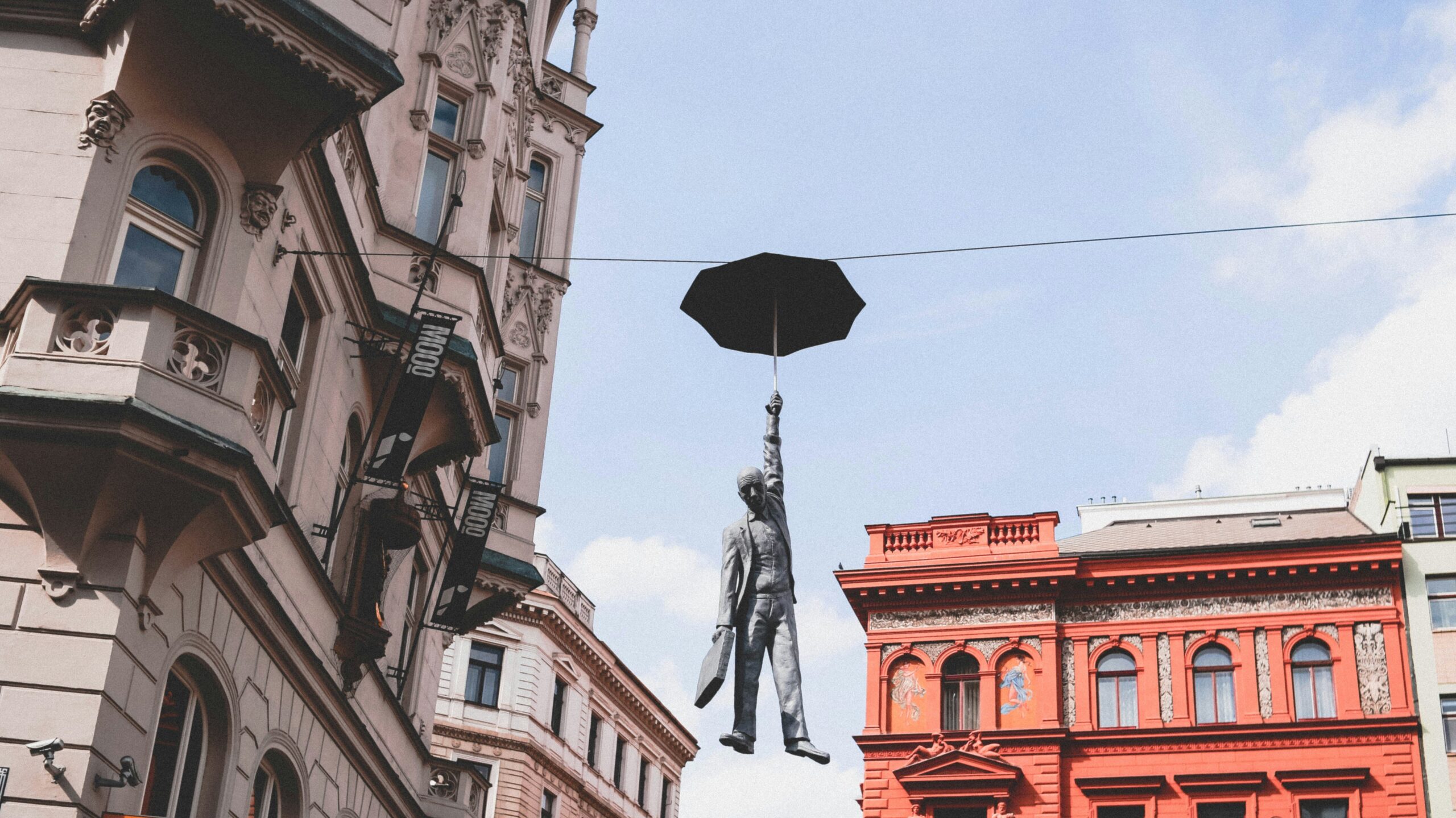 Hanging Umbrella Man statue in Prague