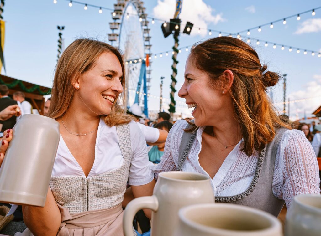 Two women enjoying a beer at Oktoberfest in Munich.