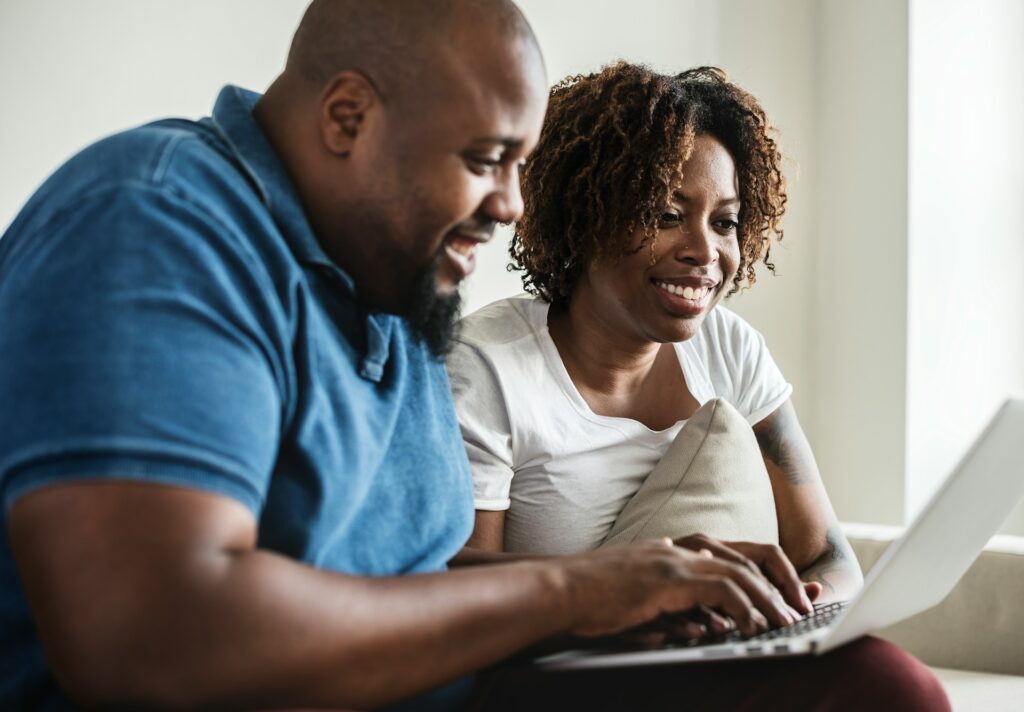 A couple using a laptop