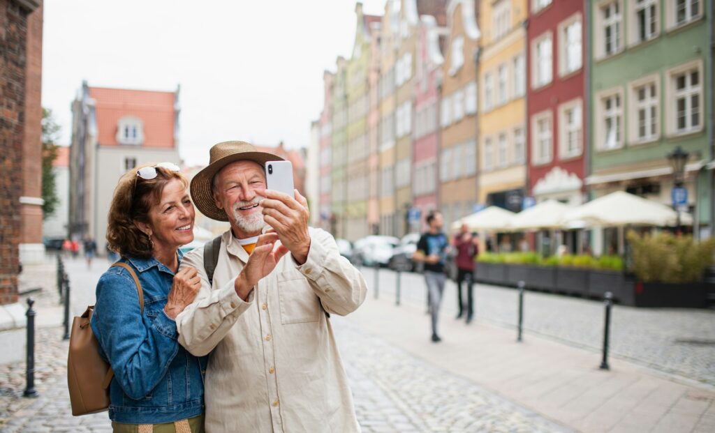 A mature couple using a phone on vacation