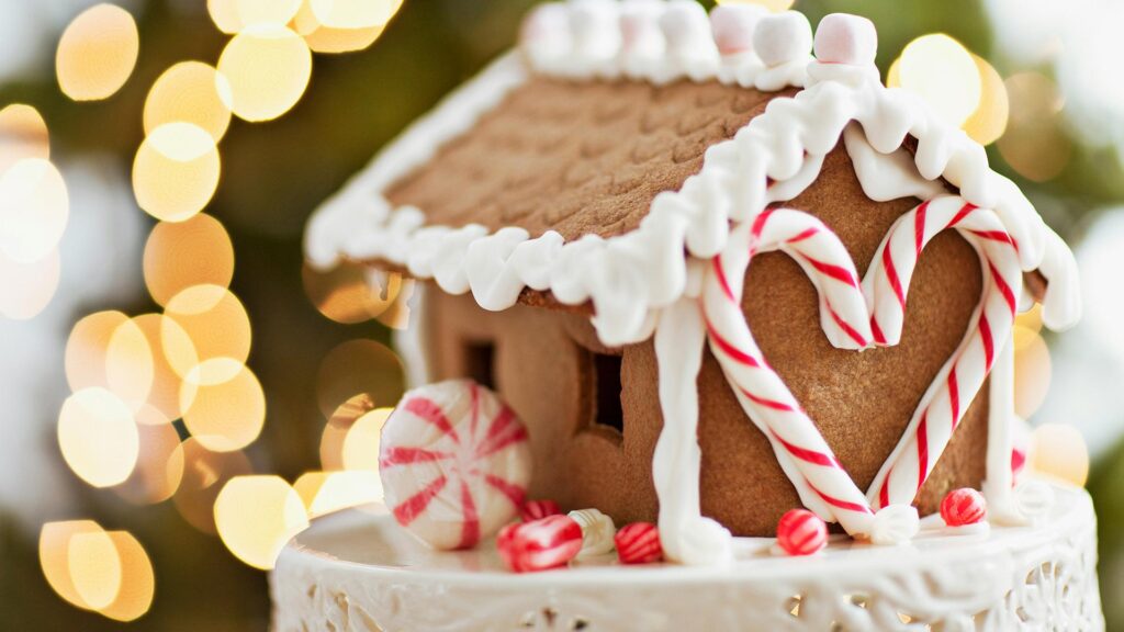 Candy canes adorning a gingerbread house at Christmastime