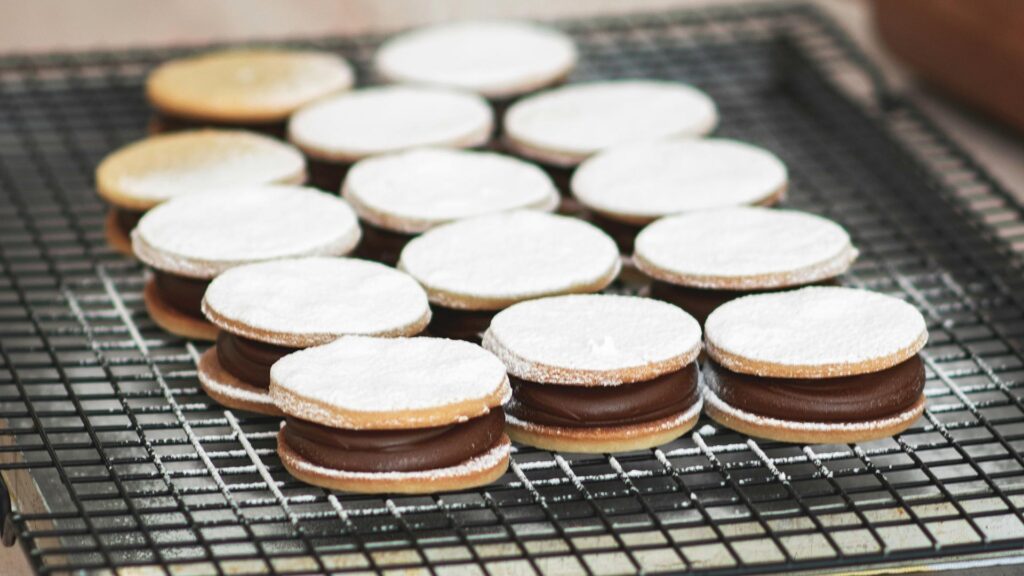 Stack of crumbly Peruvian Alfajores shortbread cookies filled with manjar blanco.