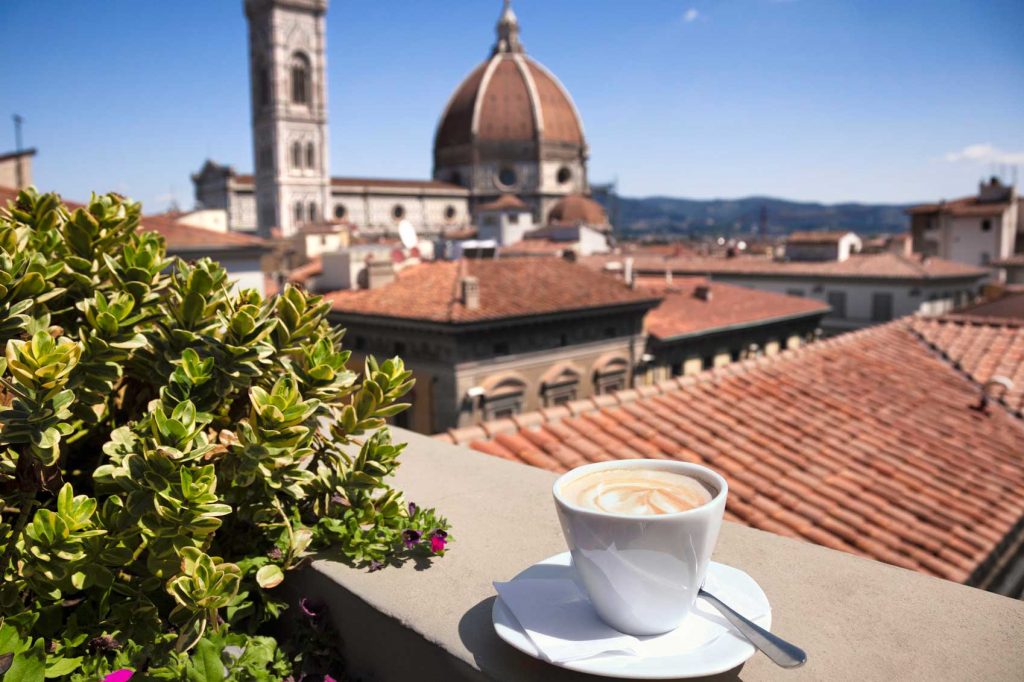 Milk coffee or cappuccino on a roof terrace with Florence's Duomo and skyline in the background 