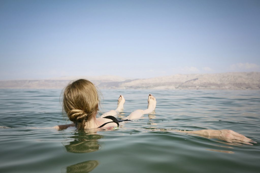A woman in a bikini floating in the dead sea.