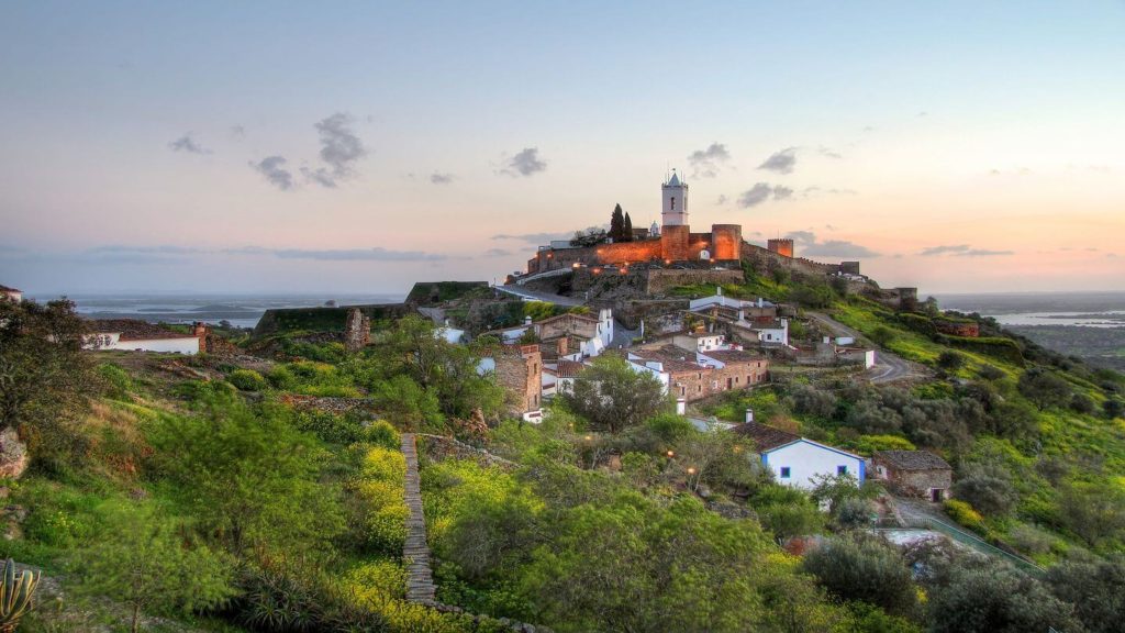A small village sits atop a hill in Portugal.