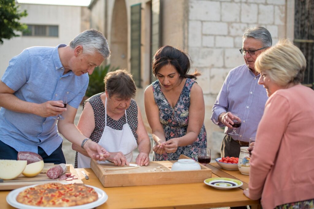 A family taking a cooking class with "nonna" in Puglia, Italy.