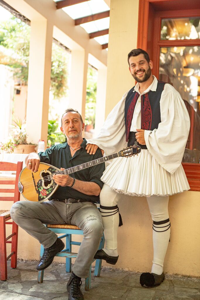 Greek men in Greece with guitar and traditional clothes