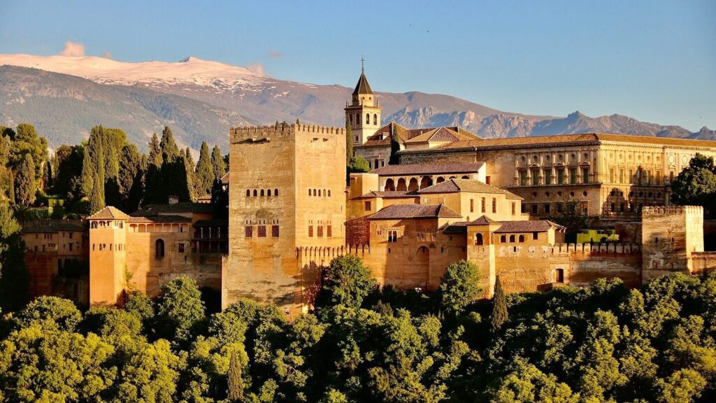 Exterior of the Alhambra palace wit snow-capped mountain in the background