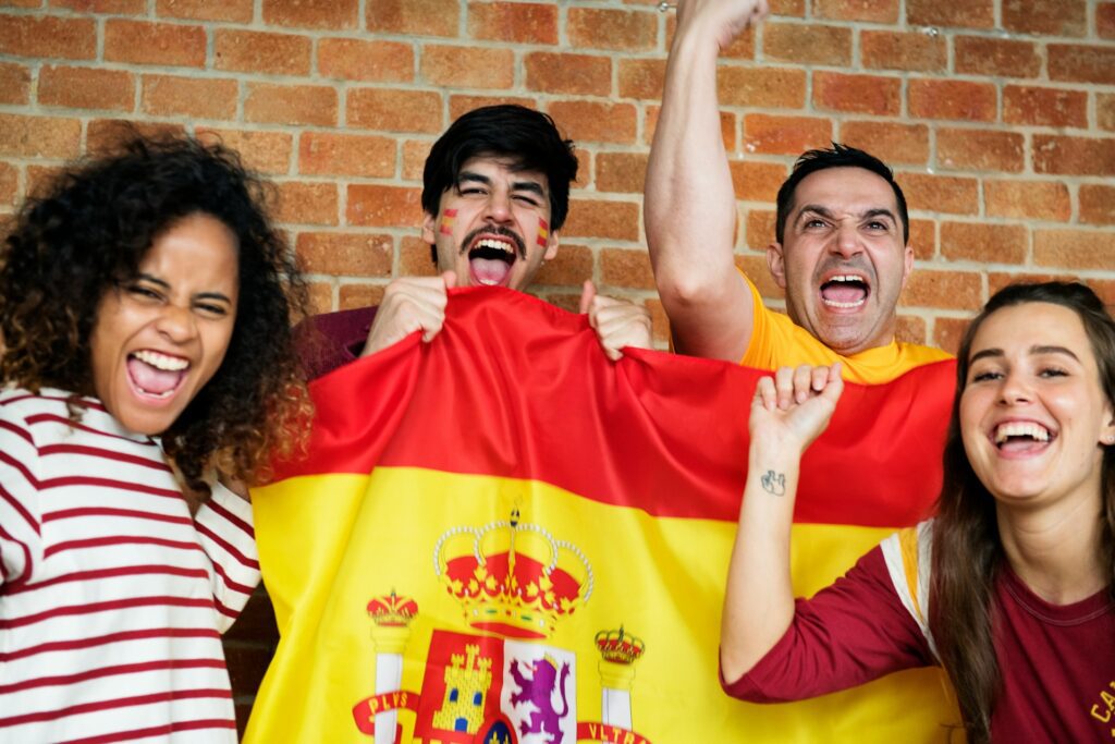 Group of people holding a Spanish flag