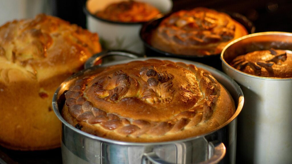 five traditional looking pies in metal casings