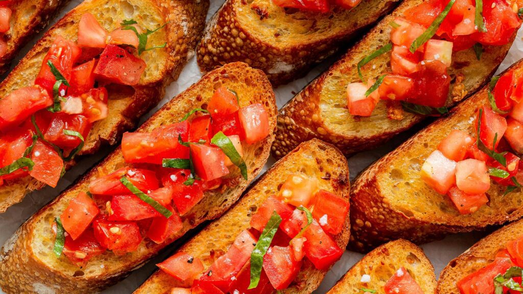 Small toasts topped with chopped tomato and sliced basil
