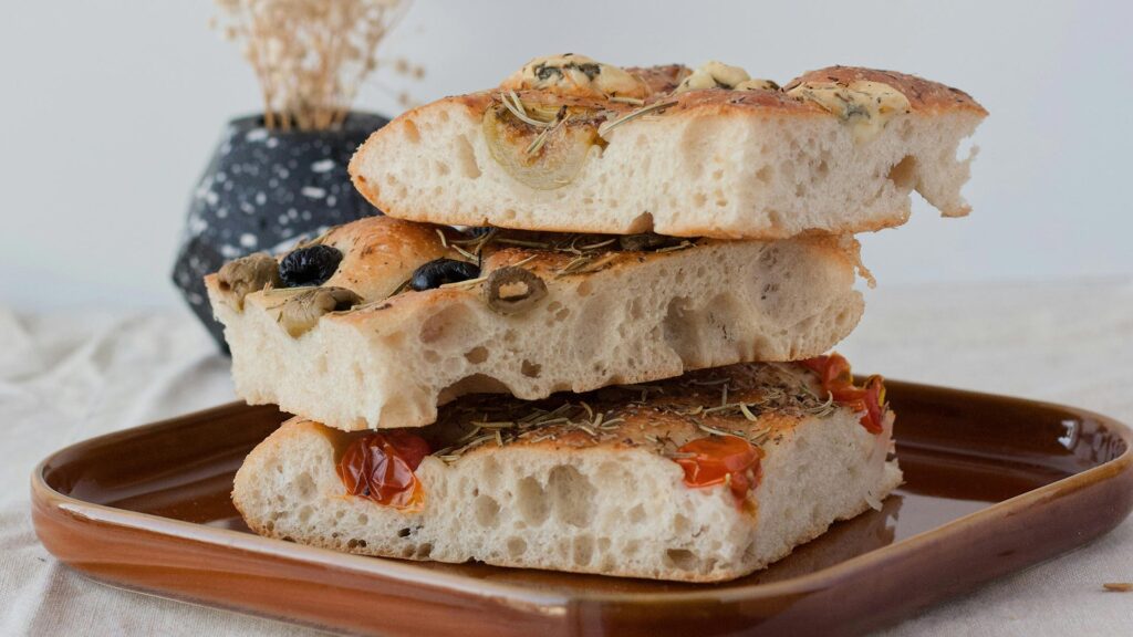 Stack of three focaccia's on a square brown plate