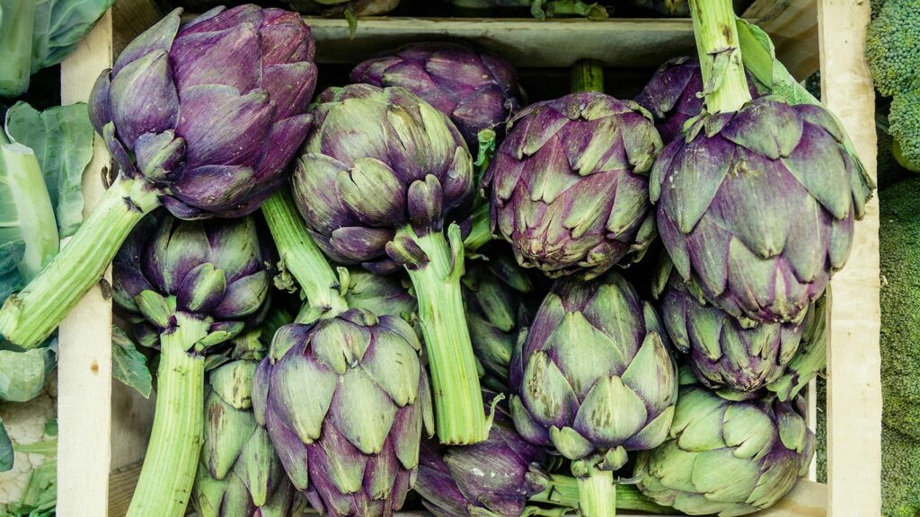 A box of artichokes at a farmer's market