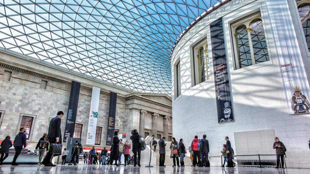 Wide view of the Great Court at the British Museum with people wandering under the glass roof